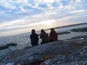 Students sitting at Coral Beach