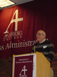 Prof. Amin Kader speaking in front of podium.