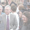 Graduates talk with family and friends in Murphy Park following Commencement in Si Melby Hall