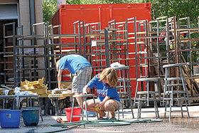 Picture of students cleaning chairs